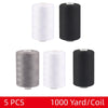 Five spools of black and white polyester thread, 1000 yards per coil, for sewing and quilting.