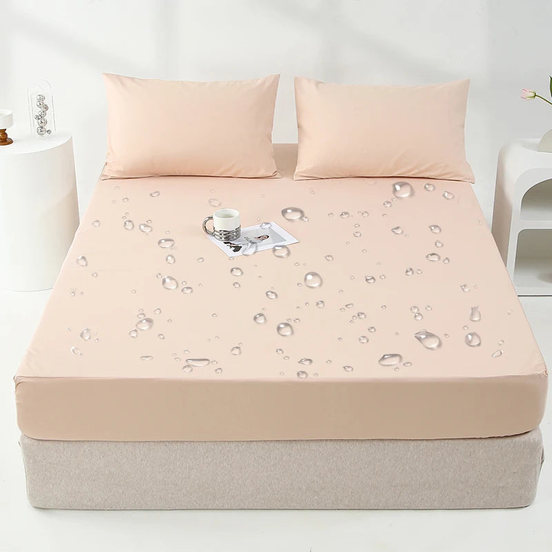 A beige waterproof mattress and bed protector sheet is shown on a mattress with water droplets.