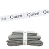 A stack of gray bed sheets with white organizer straps visible.