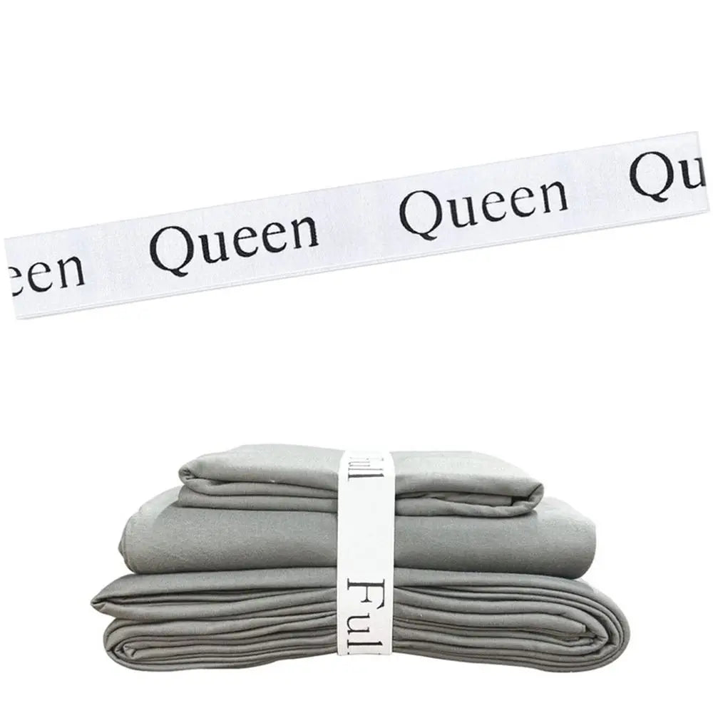 A stack of gray bed sheets with white organizer straps visible.