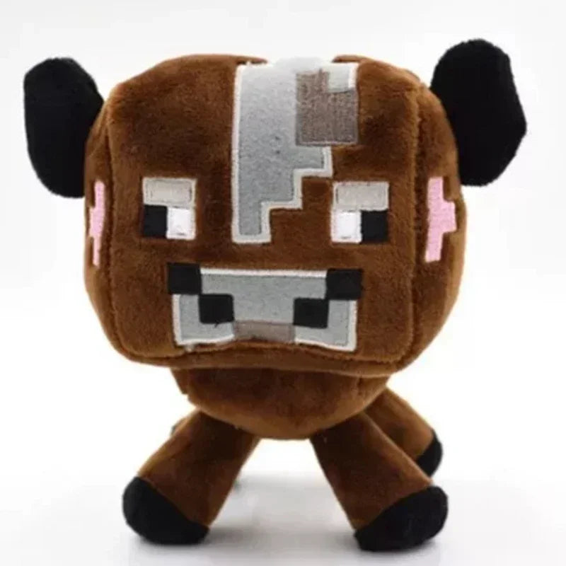 A brown stuffed dragon plush toy with black ears and white facial markings.