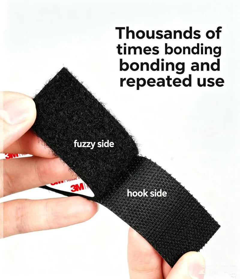 A hand holds a piece of black hook and loop tape, showing the fuzzy side and the hook side.