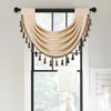 A beige European style window curtain valance with gold tassels is displayed over a window.