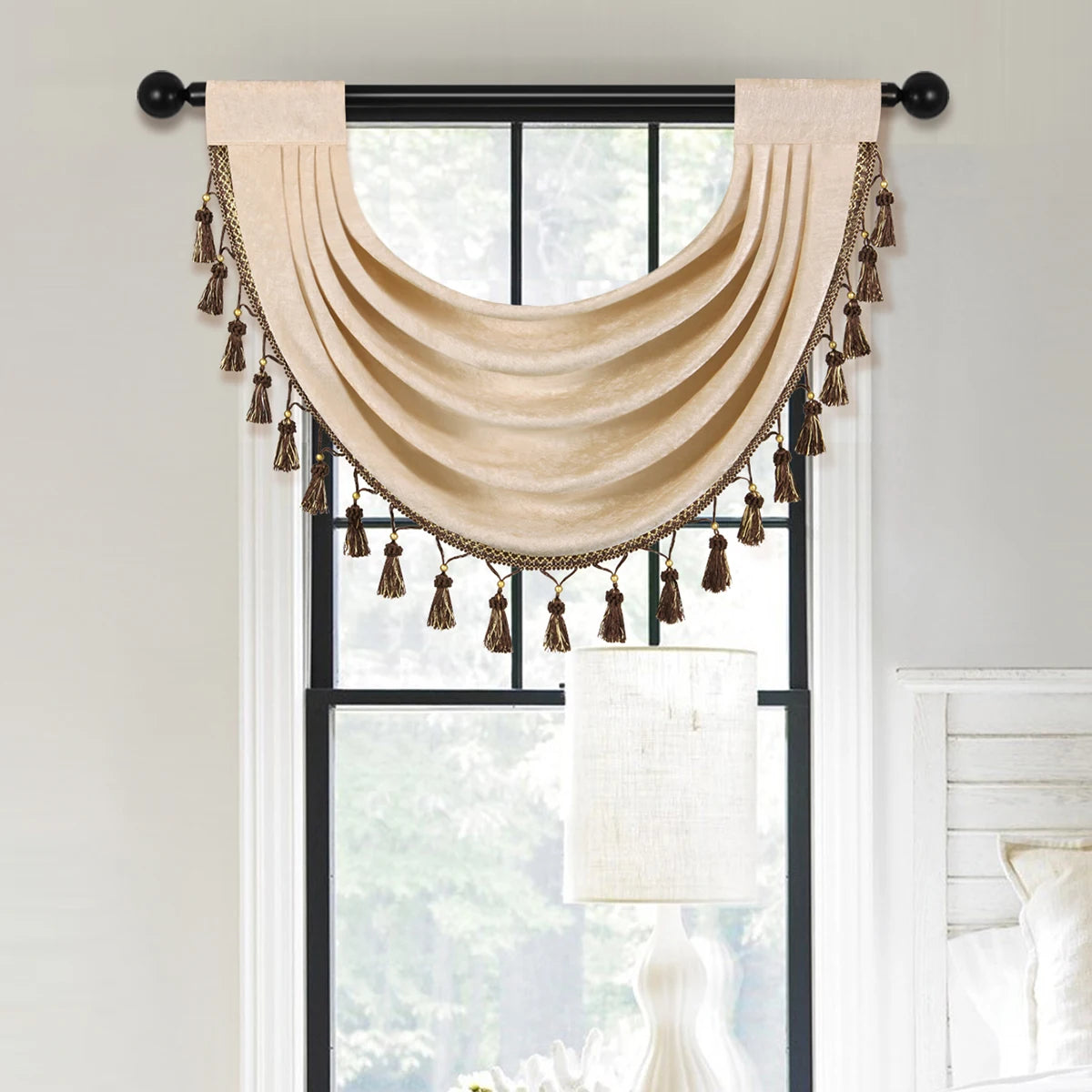 A beige European style window curtain valance with gold tassels is displayed over a window.