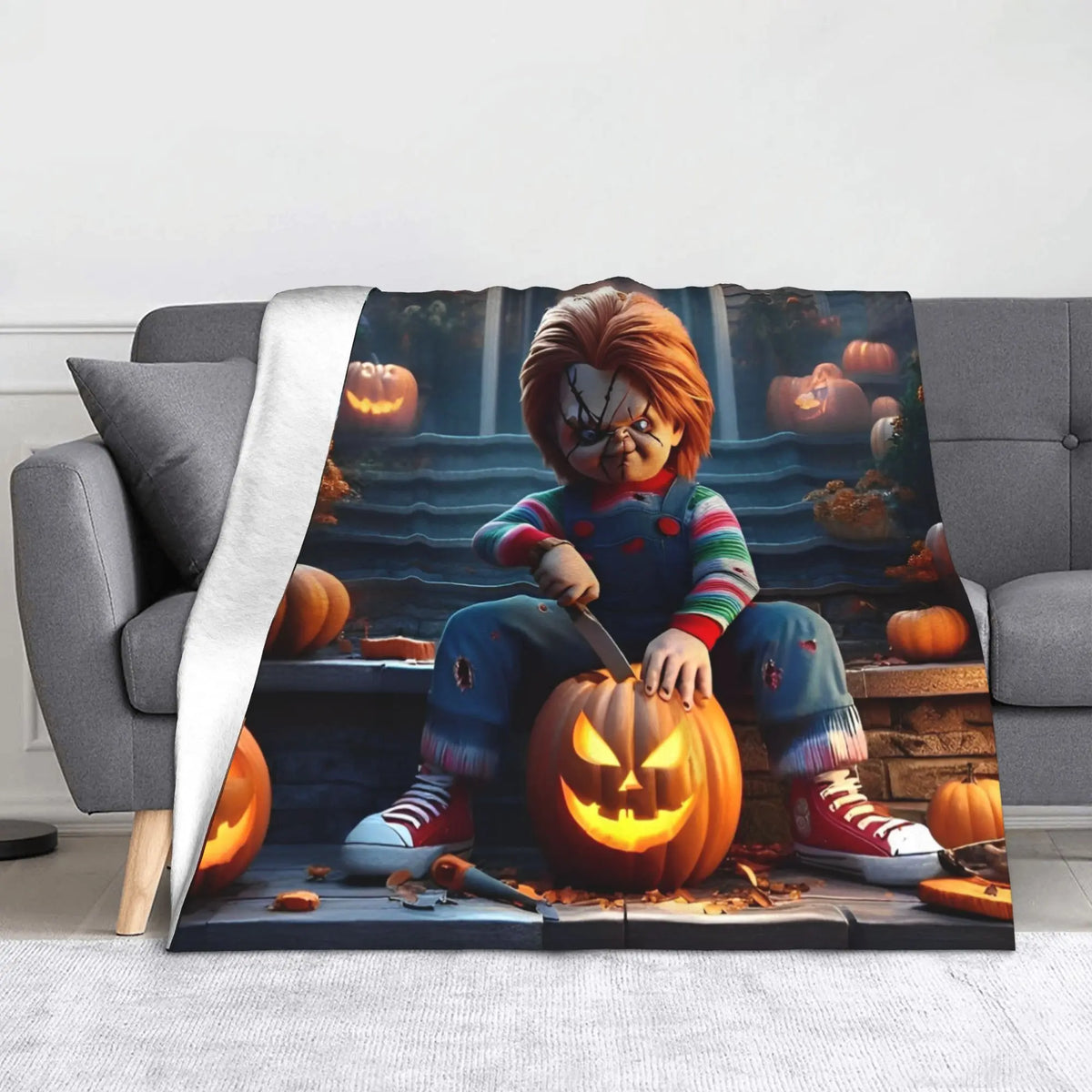 A flannel throw blanket featuring Chucky from the horror movie surrounded by carved pumpkins.