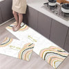 A rectangular kitchen rug with a diamond print featuring soft pastel stripes on a light wood floor.