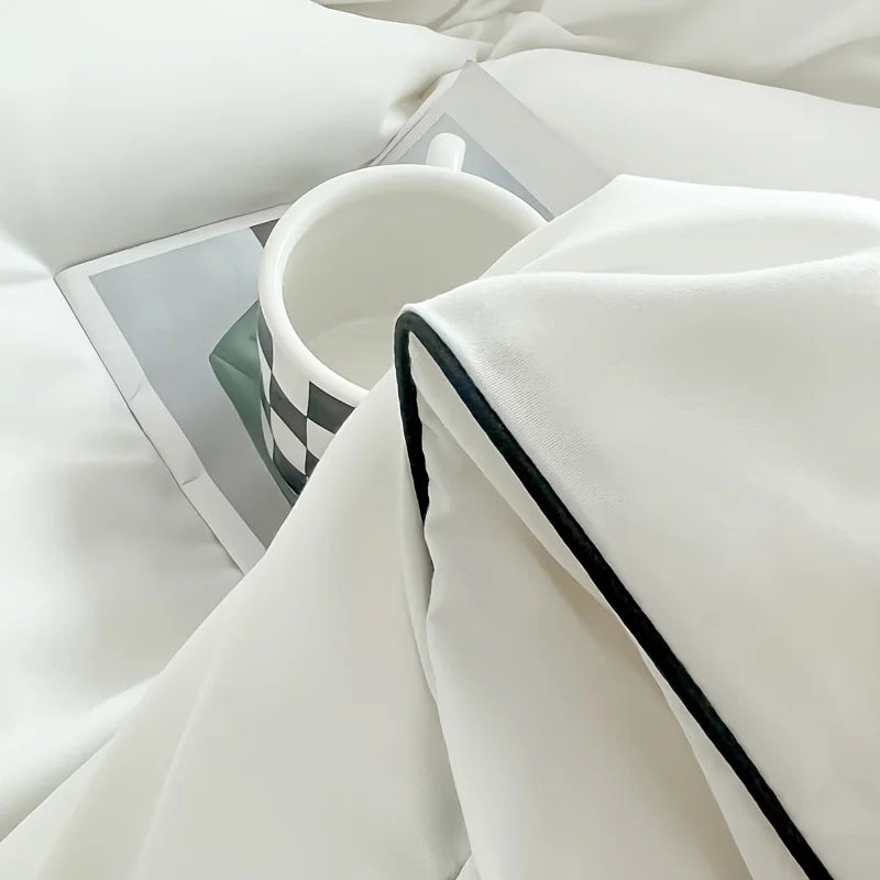 A white duvet cover set featuring a soft white duvet and matching pillow in bright natural light.