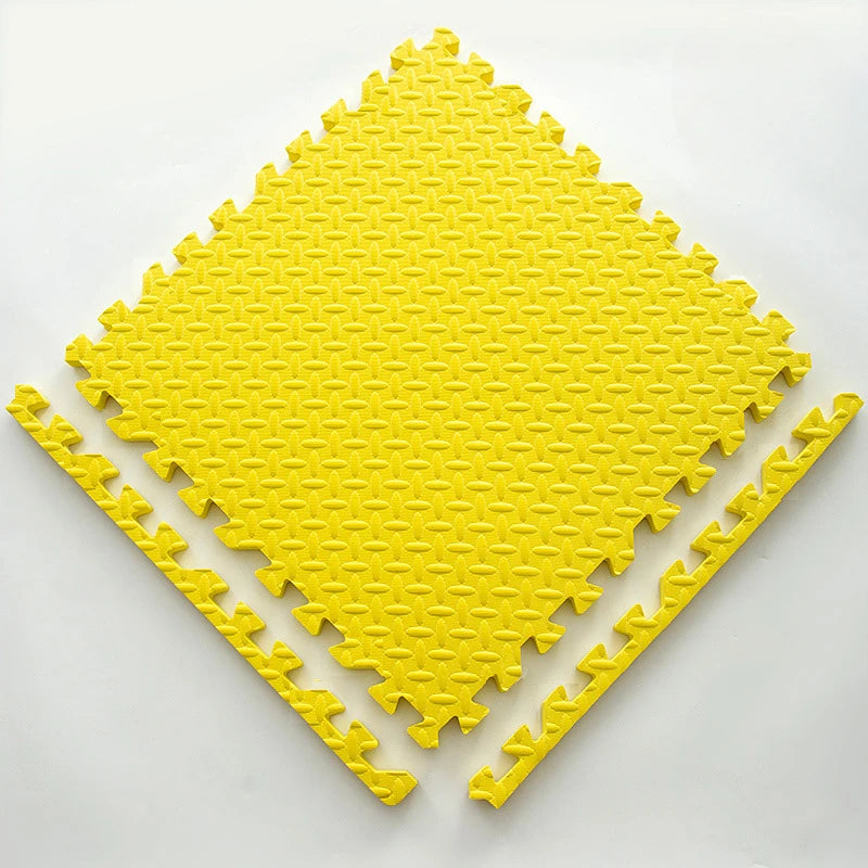 A yellow soft interlocking foam play mat shaped like a diamond, with several interlocking pieces laid out.