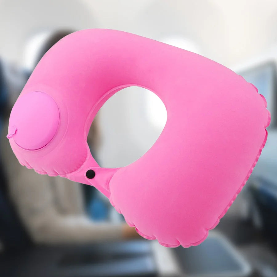 A bright pink portable flocking inflatable neck pillow is shown in a close-up view.