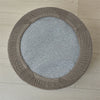 A round ottoman footrest slipcover in brown fabric with ribbed edges and a gray textured center.