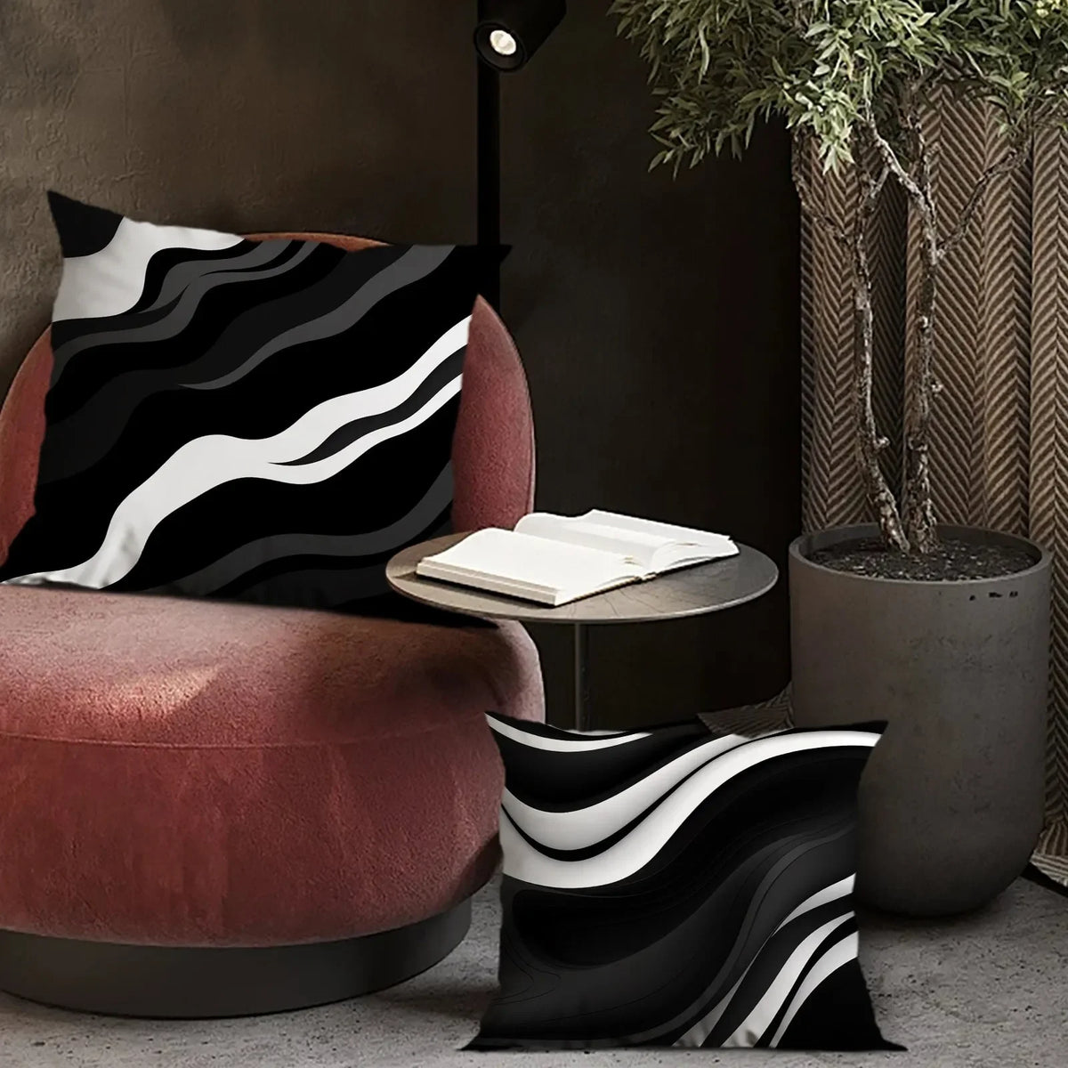 A decorative pillowcase with a black and white wavy geometric pattern resting on a pink armchair.