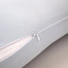 A close-up of a light gray ergonomic double wave curve pillow showing the seam and zipper detail.