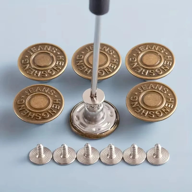 A set of gold-toned metal snap buttons and a silver pin on a stick, with several individual buttons displayed.