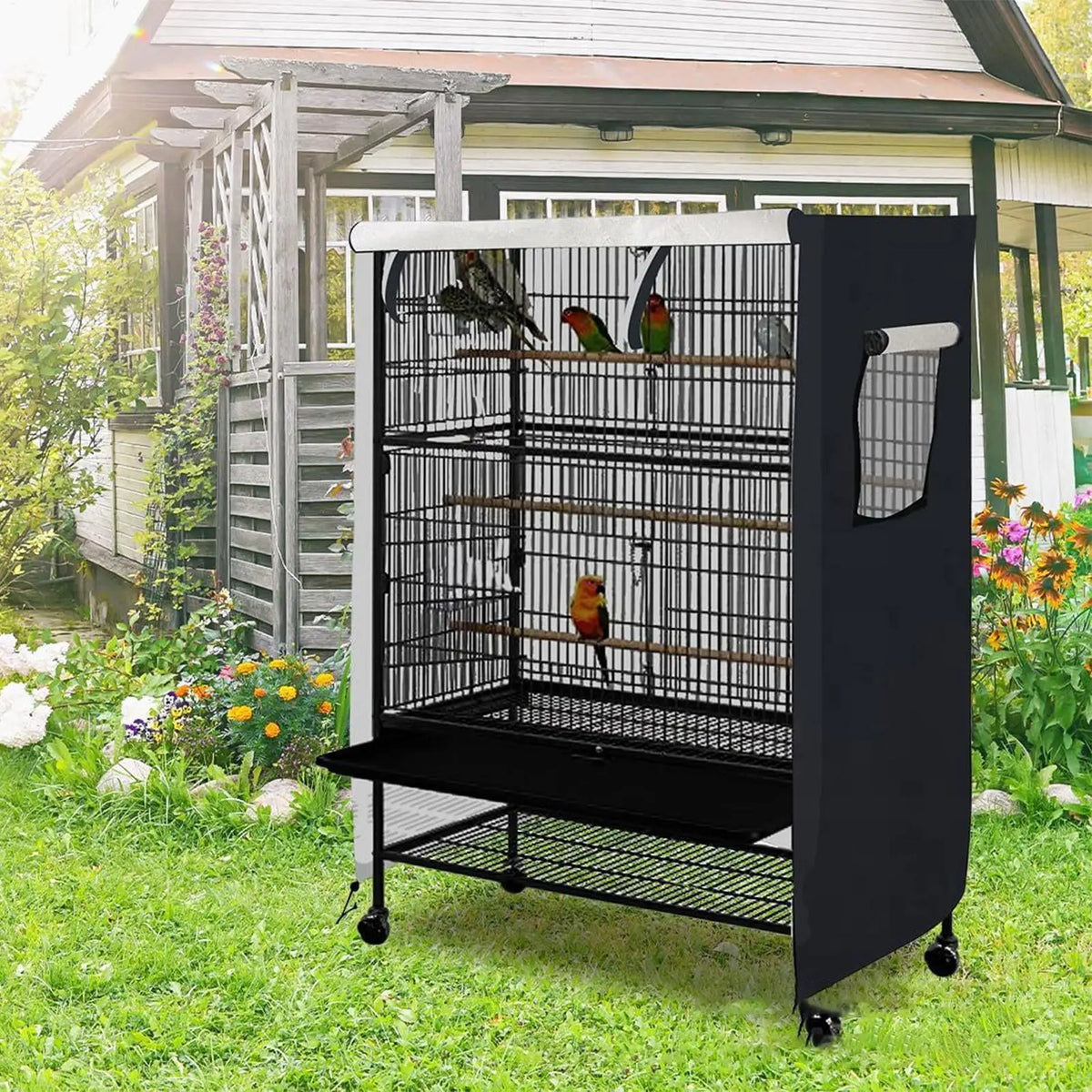 A black waterproof bird cage with a wire mesh roof and side panels is placed outdoors on grass.