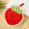 A plush strawberry shaped hanging hand towel in red and green with a white border.