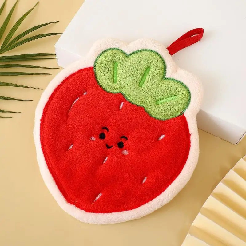 A plush strawberry shaped hanging hand towel in red and green with a white border.