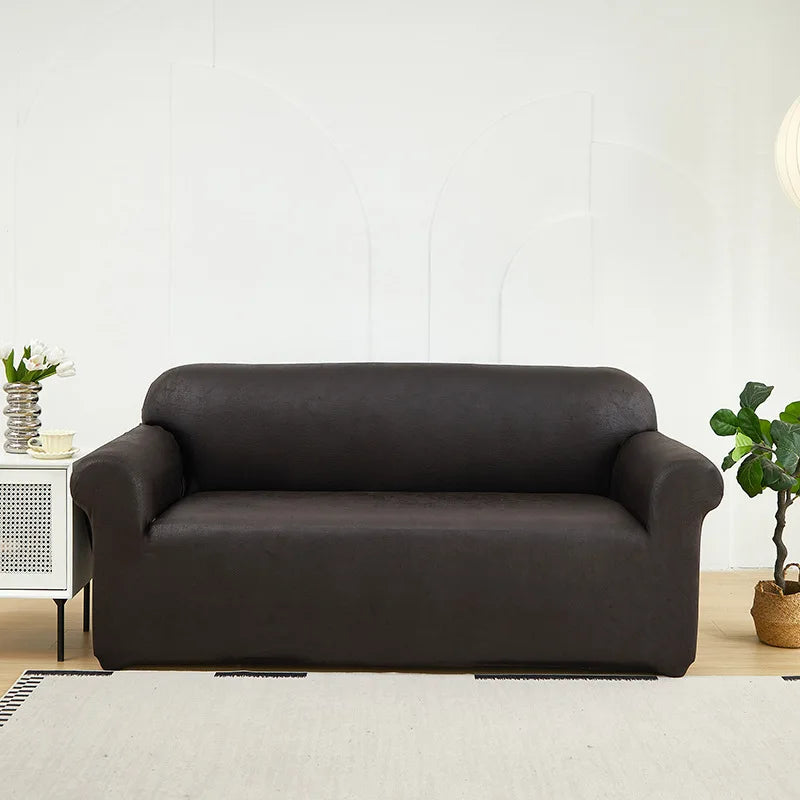A dark brown PU leather sofa slipcover placed in a bright living room setting.