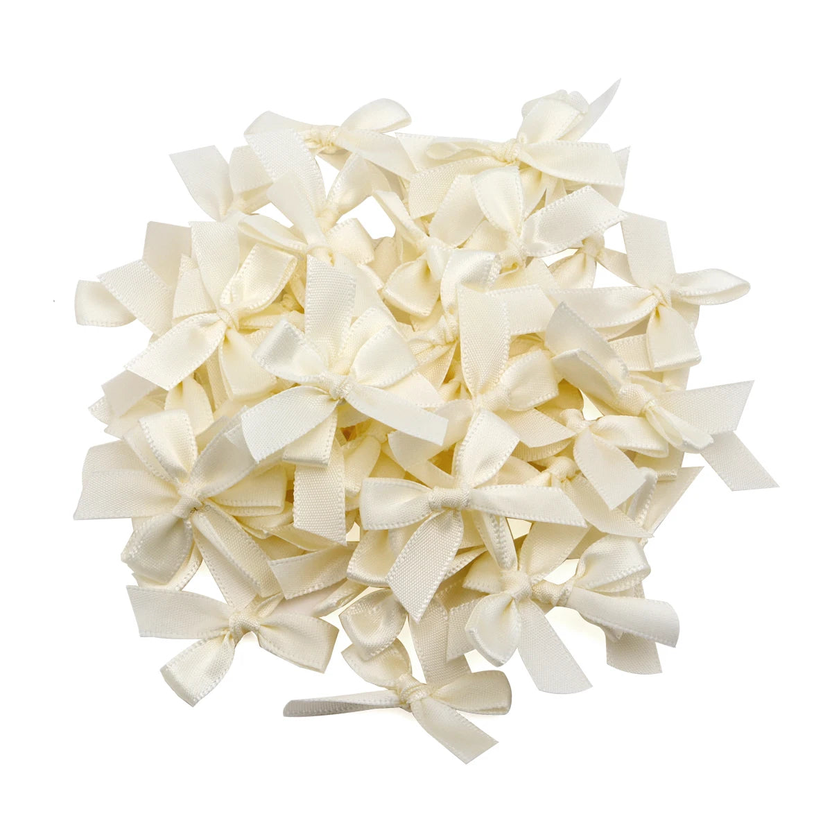 A pile of cream or ivory satin ribbon bows for craft and decoration.