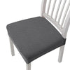 Gray removable polyester bar and dining seat covers on a white wooden chair.