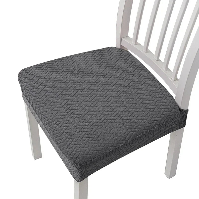 Gray removable polyester bar and dining seat covers on a white wooden chair.