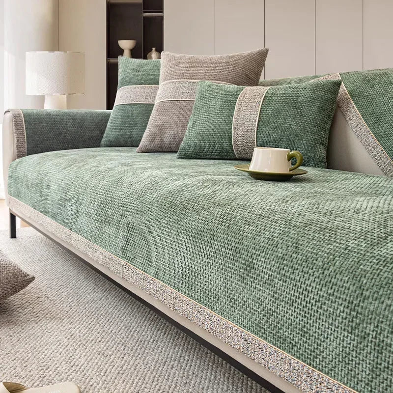 A green linen sofa cover with gray accents and pillows on a light-colored sofa.
