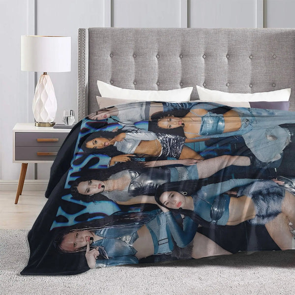 A cozy K-Pop fleece throw blanket featuring multiple women in various poses and outfits.