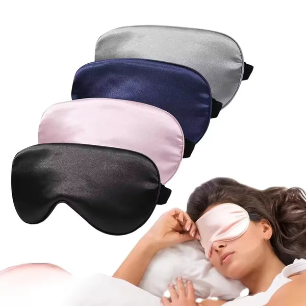 A woman is wearing a pink silk sleep mask while resting, with several colored masks displayed nearby.