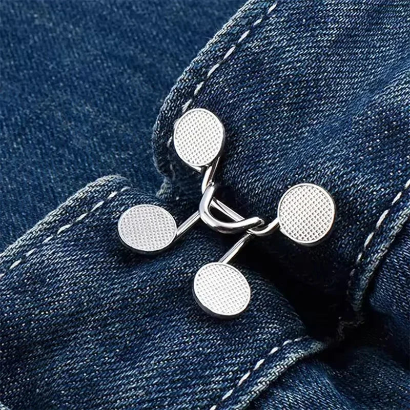 Silver metal button snaps attached to a dark blue denim fabric
