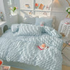 A light blue soft textured duvet cover set with matching pillowcases displayed on a bed.
