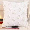 A white textured corduroy throw pillow cover with vertical stitching details.