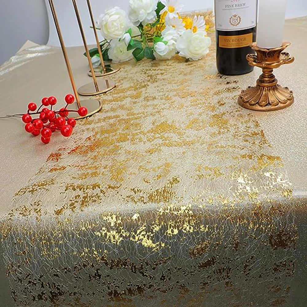 Gold glitter sequin table runner displayed on a table with white roses and a bottle of wine