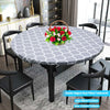 Round gray and white patterned elastic-edged vinyl tablecloth set with black dining chairs