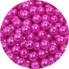 A pile of pink imitation pearl beads used for DIY jewelry making.