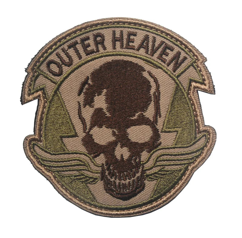A military-style embroidered patch featuring a skull design and the text OUTER HEAVEN on a tan background.
