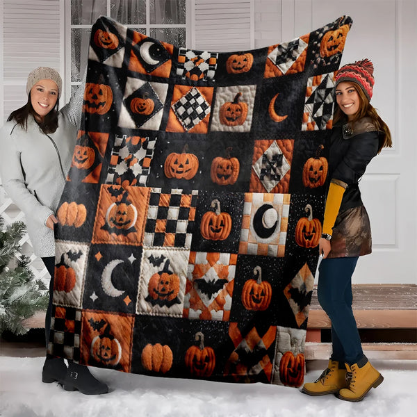 A woman models a vintage patchwork flannel throw blanket decorated with Halloween pumpkins and bats.