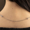 A silver chain necklace with an adjustable lobster clasp is displayed against a person's neck.