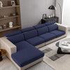 A modern navy blue jacquard knit sofa cushion cover on a light beige sofa in a living room setting.