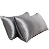 A set of two smooth, gray satin silk pillows for hair and skin.