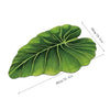 A green, leaf-shaped quick-dry bathroom mat with a rubber backing shown from above.