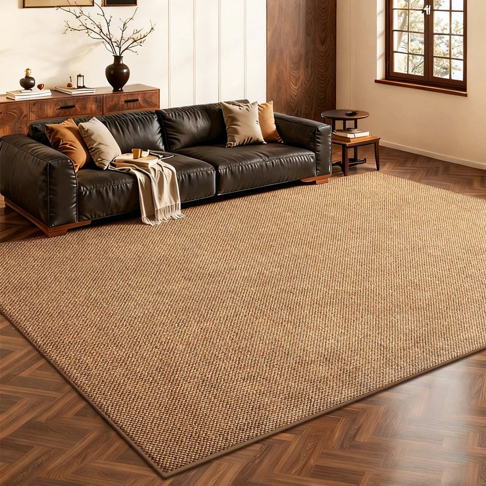 A rectangular woven sisal runner rug in natural brown tones placed on a wooden floor.