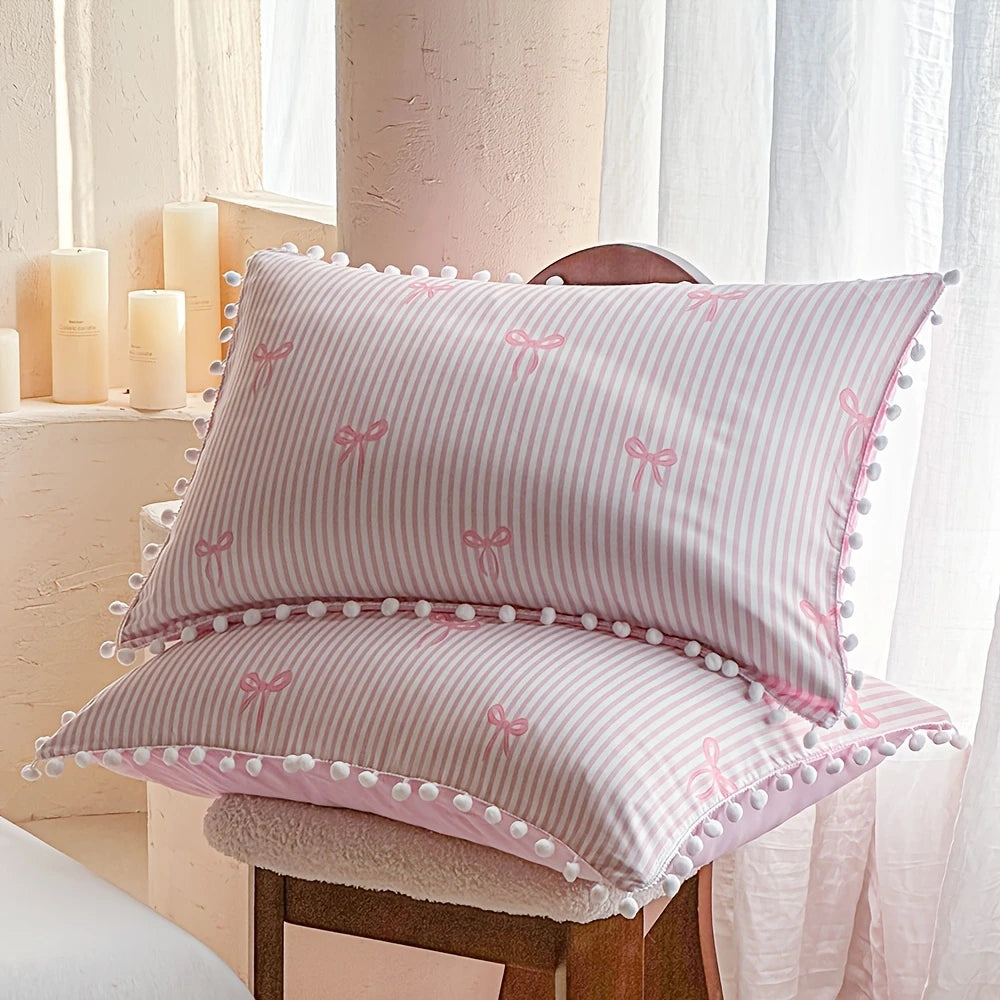Pink and white striped quilt duvet set with pillowcases featuring pink bow prints