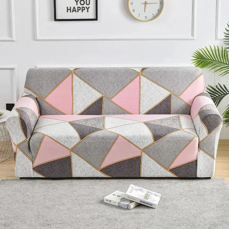 A gray sofa cover protector featuring a geometric pattern of pink and gray triangles.