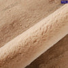 Close-up of a beige plush bear-shaped non-slip area rug texture.