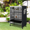 A black and white waterproof bird cage with a mesh roof is placed outdoors on a green lawn.