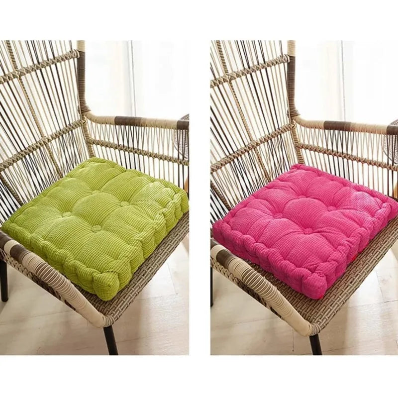 A woven rattan chair with a lime green and a pink tufted floor seat cushion.