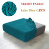 A teal velvet fabric is shown folded and draped over a gray sofa seat cover.