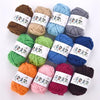 A collection of twelve soft acrylic yarn skeins in various colors including brown, green, blue, gray, orange, and pink.