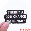 Black embroidered patch with white text that reads There's a 99% chance I'm hungry