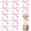 A collection of satin ribbon twist tie bows in various colors and sizes displayed on a metal rack.