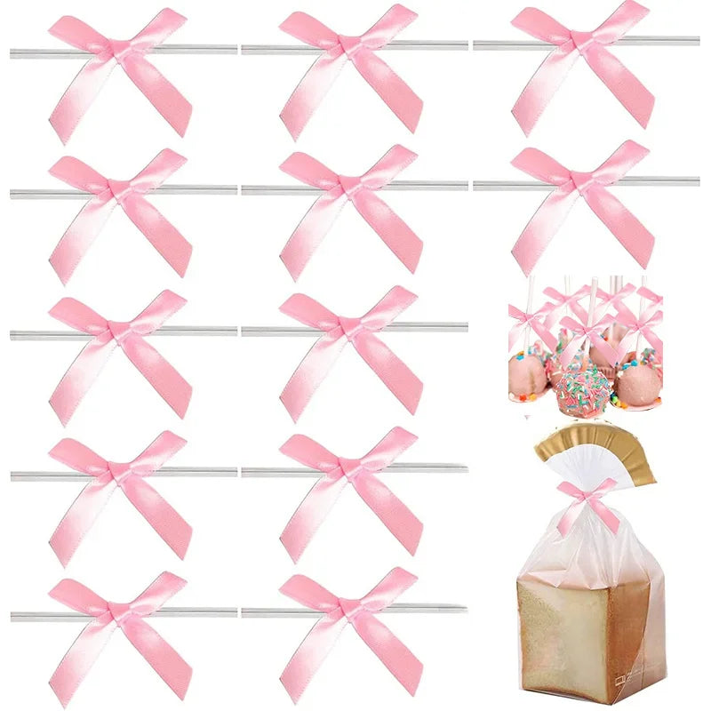 A collection of satin ribbon twist tie bows in various colors and sizes displayed on a metal rack.
